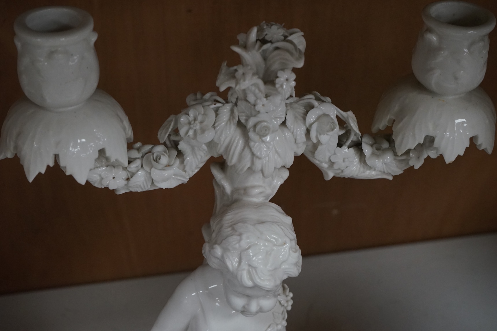 A pair of figural two branch candelabra, crossed swords marks, 36cm high